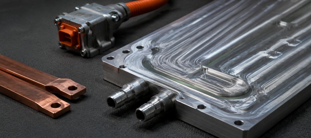 Machined aluminium EV battery cooling plate, tinned copper busbars and a high-voltage connector body